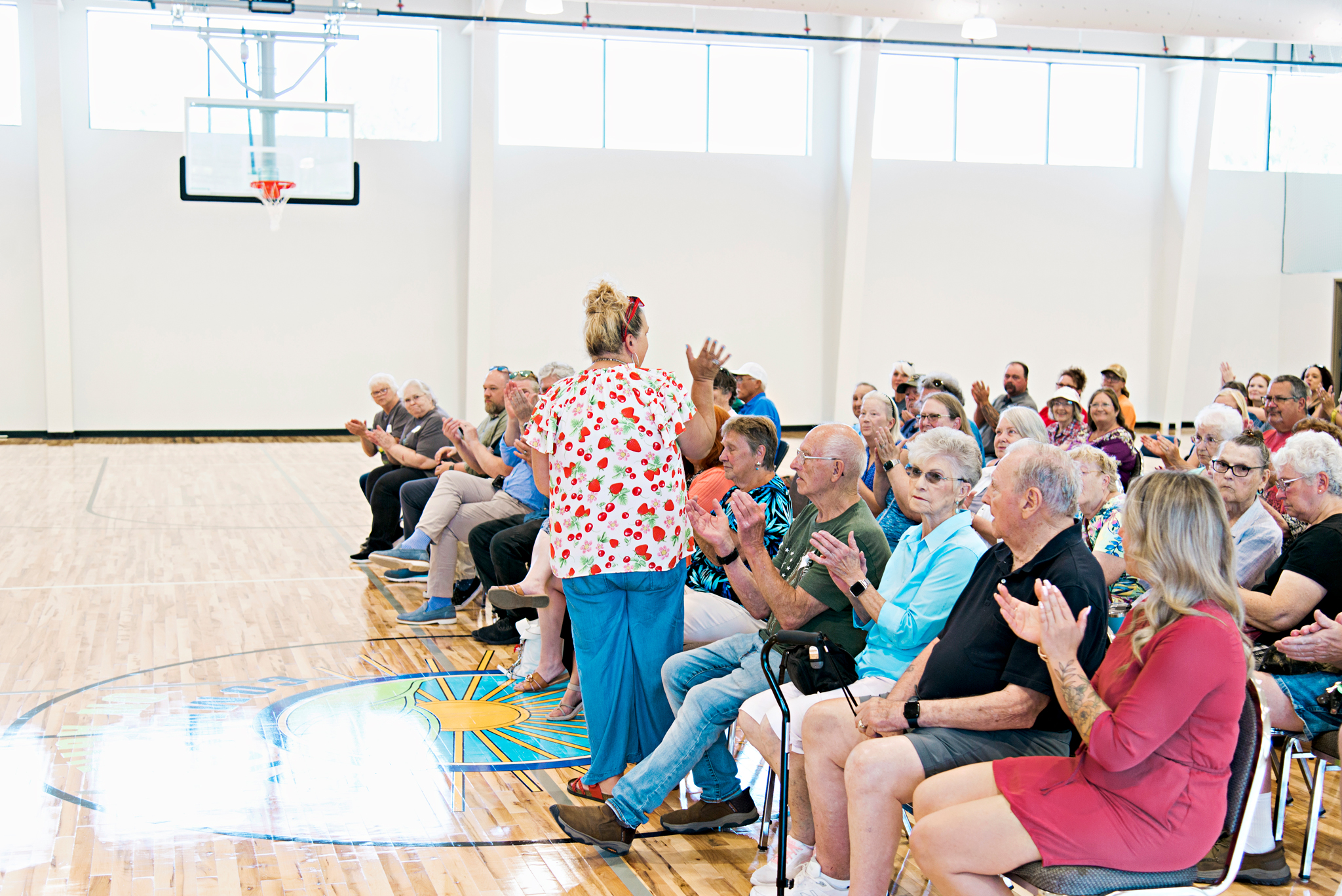 ACCOA Executive Director Wendy Bain waves to the audience.