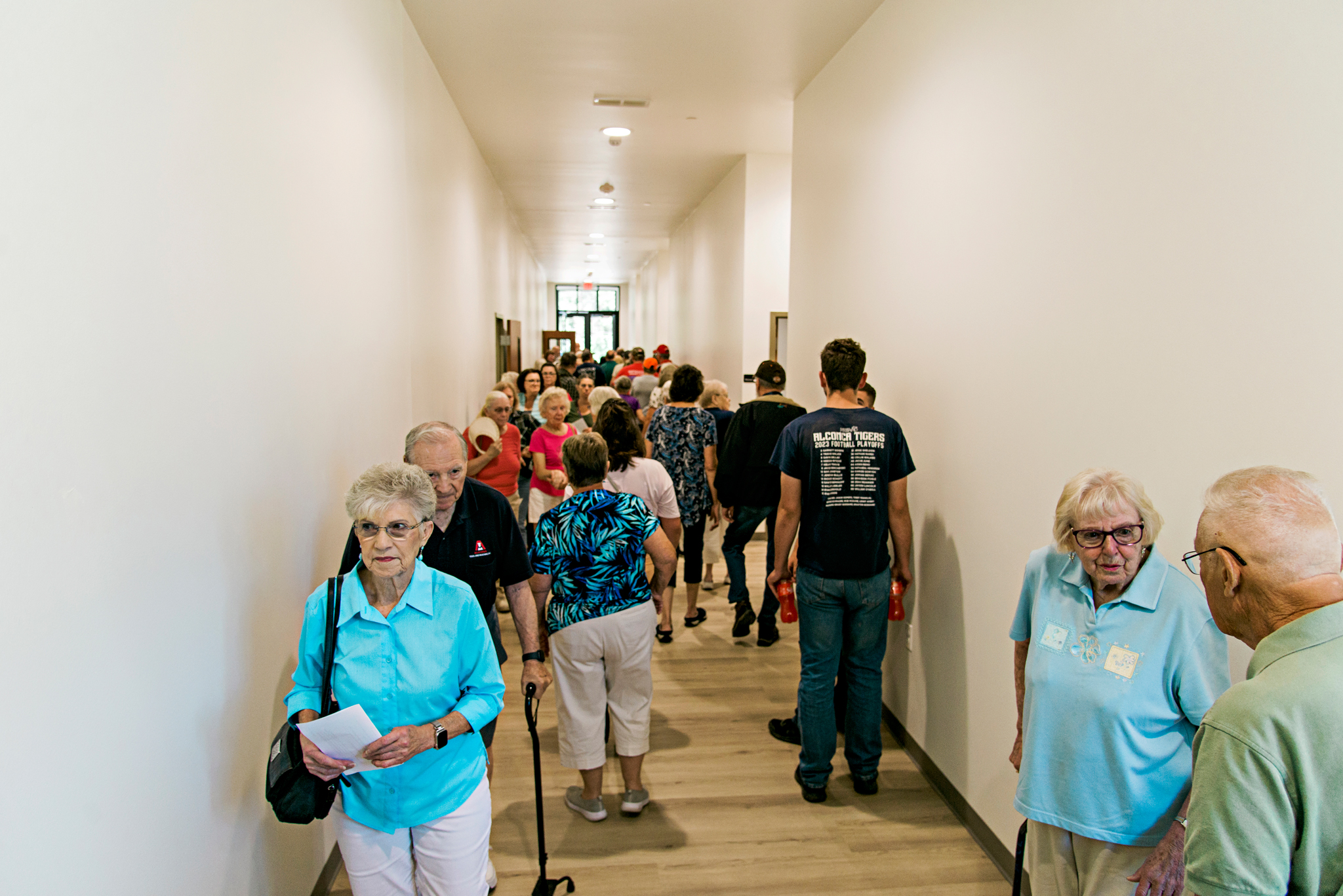The crowd eagerly explores the new senior community center.